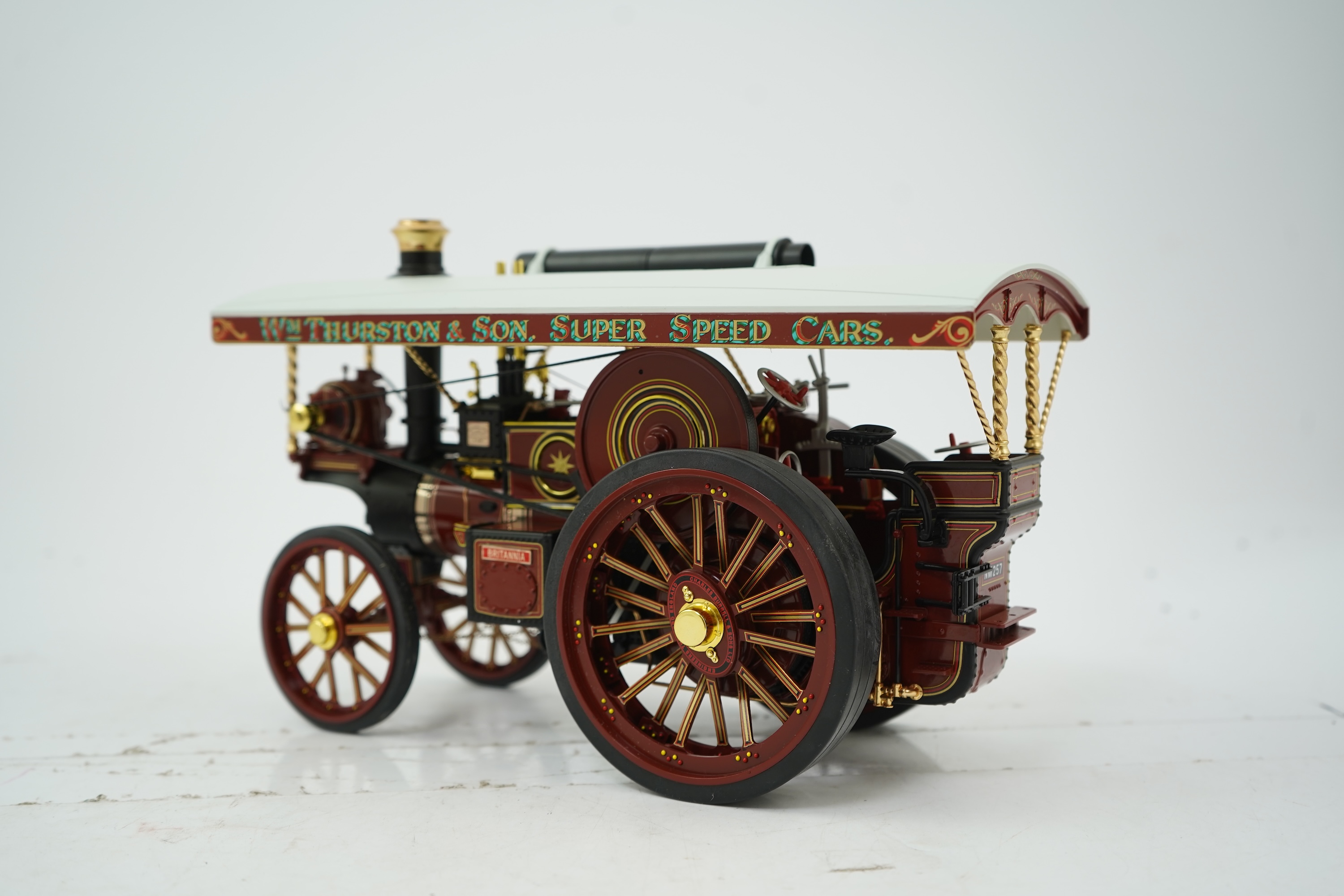 A Midsummer Models Ltd. 1:24 scale model of a Burrell Showman’s Engine, Britannia, in William Thurston and Son. Super Speed Cars livery, missing the original card box, but with an oak and Perspex display case